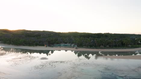 Perfect-serene-morning-on-tropic-coast-of-Fiji-with-low-seawater-in-bay,-aerial