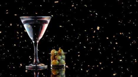 martini glass and olives with golden confetti animation on black background