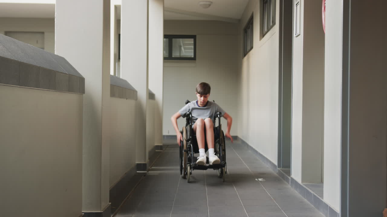 Boy in wheelchair navigating school hallway, focusing on movement and balance