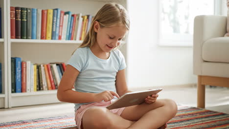 young girl using a tablet at home