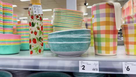 vibrant plastic bowls and plates on shelves