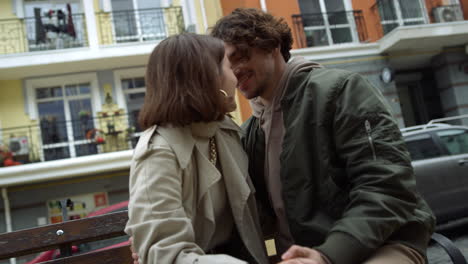 love couple kissing on city background. woman throwing legs over man outdoor.