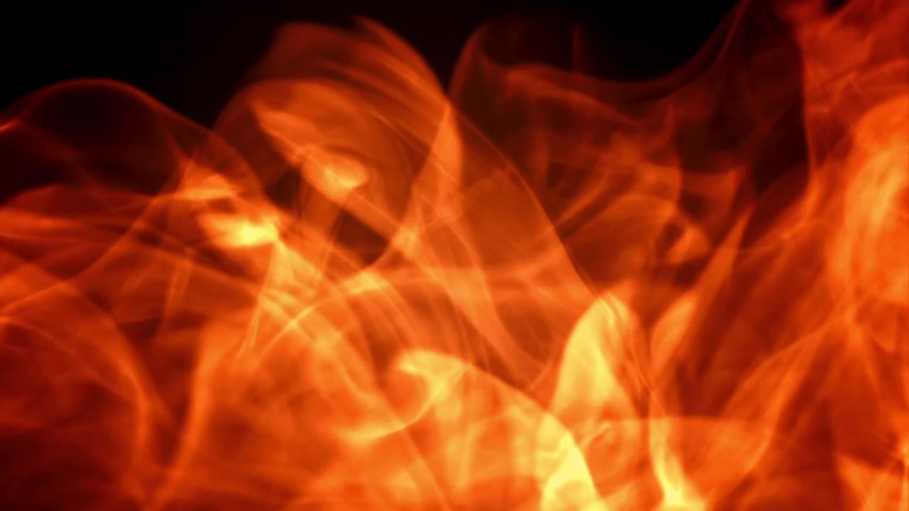 Humo abstracto rojo y naranja arremolinándose sobre fondo negro.