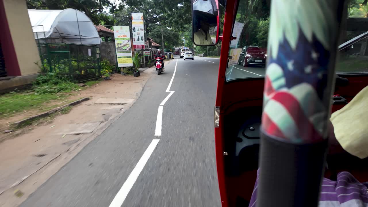 Tuk tuk ride through the bustling streets and lush surroundings of Kandy, Sri Lanka. The dynamic view captures the essence of everyday local life.
