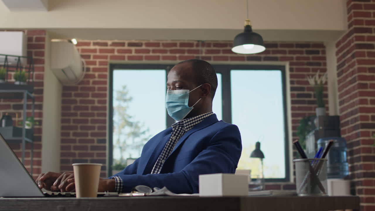 Financial analyst with face mask working on business presentation