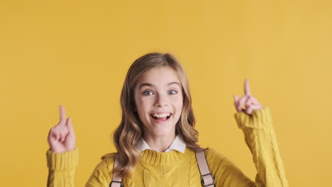 happy teenage caucasian girl with thumbs up wearing backpack.