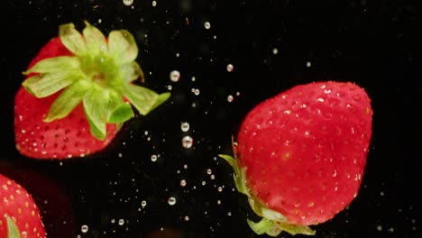 strawberries splashing in water