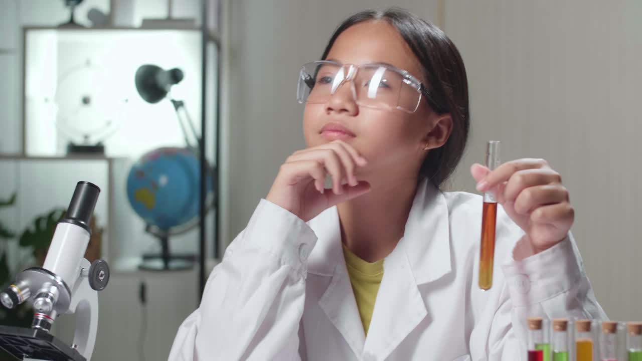Young Scientist Girl Looking At Microscope And Thinking In Laboratory Experiment With Liquid