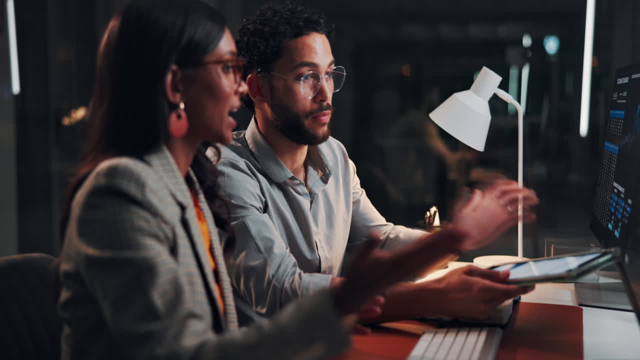 Business Colleagues Discussing Data and Project Strategy in Office at Night