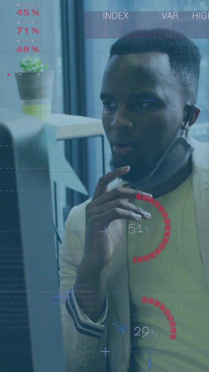 Animation of financial data processing over businessman with face mask using computer in office