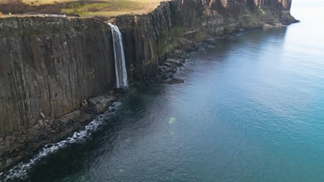 Backwards-drone-dolley-tilt-shot-of-the-mealt-falls-on-the-coast-of-Scotland