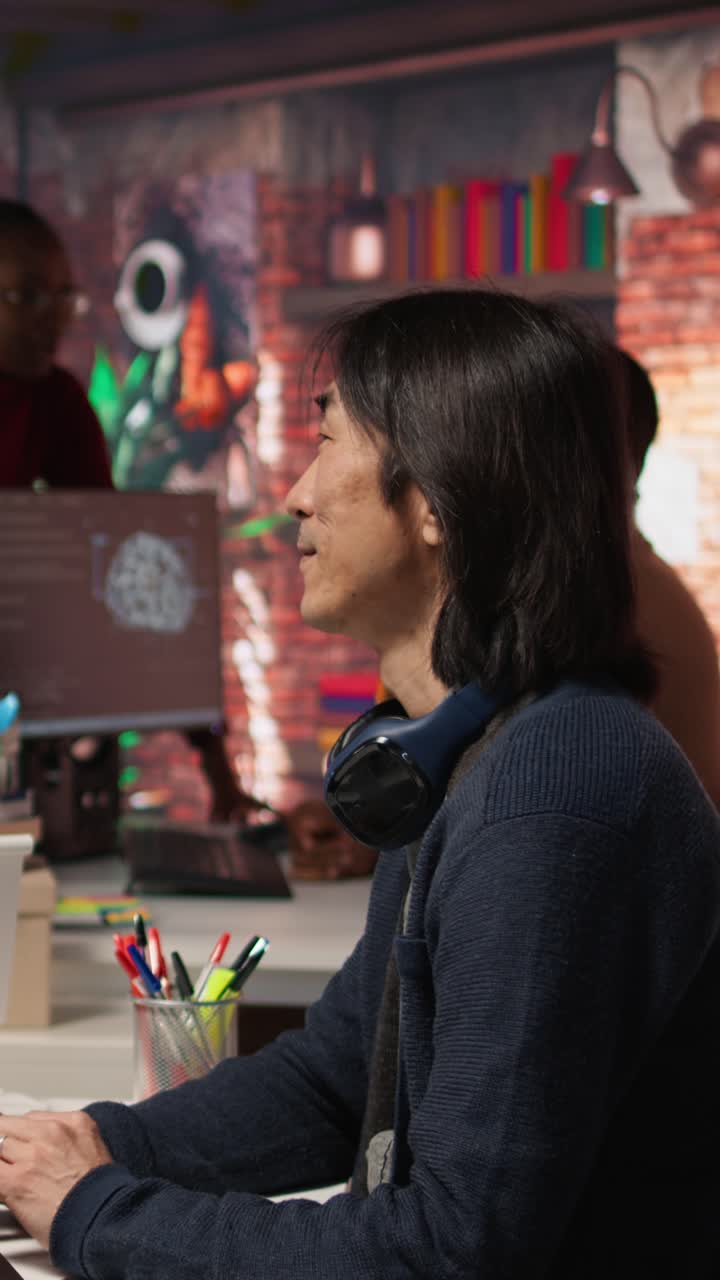 Vertical video AI startup intern holding laptop asks questions to senior technician