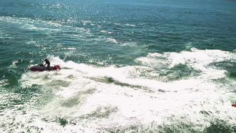 close up of a jet ski doing stunts in open water during summer