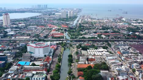 aerial cityscape view of the ocean and kota tua in north jakarta on sunny day