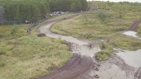 aerial view of dirt bike race through muddy terrain