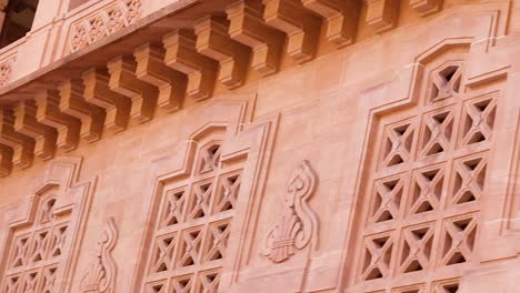 artistic design of palace wall made of red stone at day from flat angle video is taken at umaid bhawan palace jodhpur india