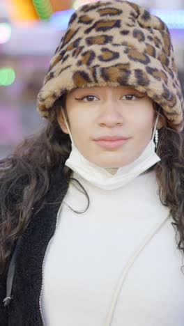 a young woman in a leopard print hat