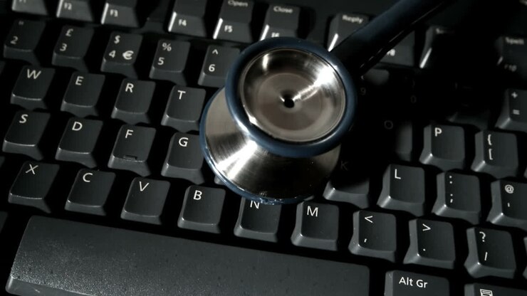 Stethoscope falling onto computer keyboard and bouncing