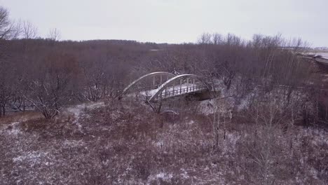 stark winter aerial approaches abandoned old highway bridge to nowhere