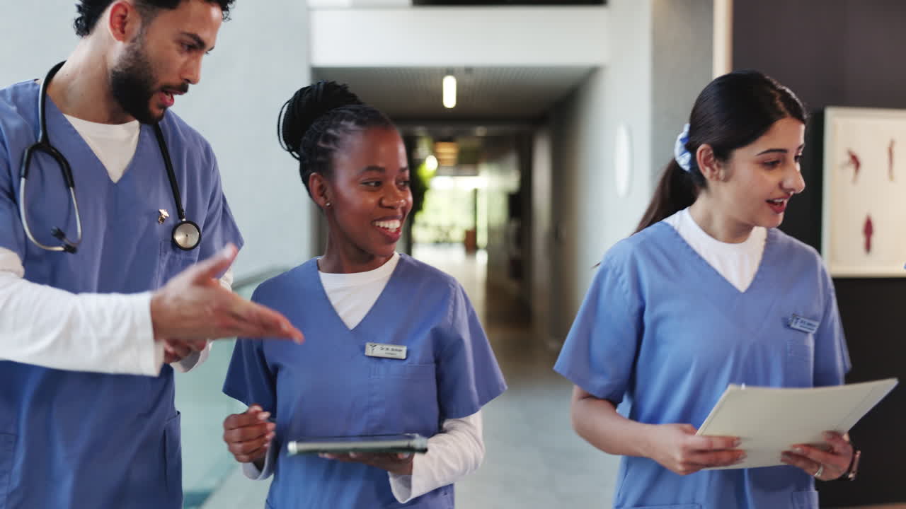 Diverse Medical Team Walking and Discussing in Hospital Hallway
