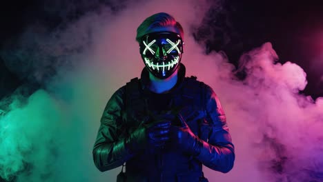 person in glowing led mask surrounded by colorful smoke