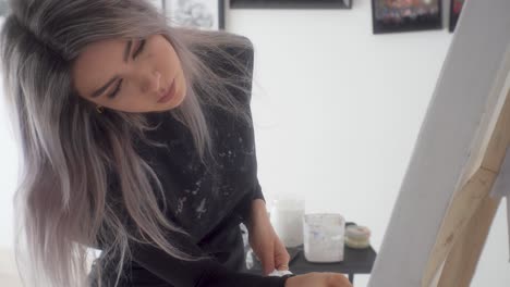 a creative latina woman doing an artwork inside the studio