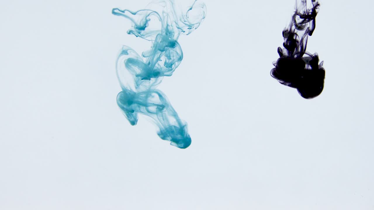 4K footage of colorful ink drops in water, isolated abstract background. Pouring ink in water. Underwater paint mix. Slow psychedelic dye swirls, colored smoke explosion. Splashing, floating liquid