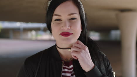 portrait-of-cool-alternative-young-woman-smiling-confident-mysterious-at-camera