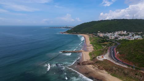 aerial drone shot of vizag city by the ocean, highlighting the city’s coastal beauty and vibrant waterfront.