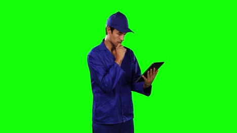 Front-view-of-mechanic-using-digital-tablet-with-green-screen