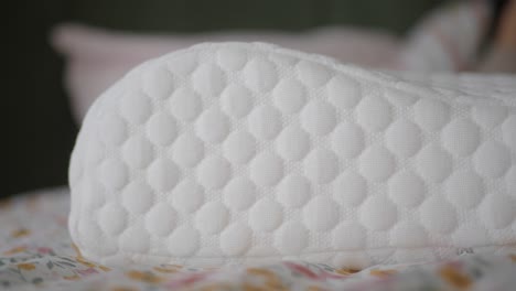 close-up of a white quilted pillow on a bed