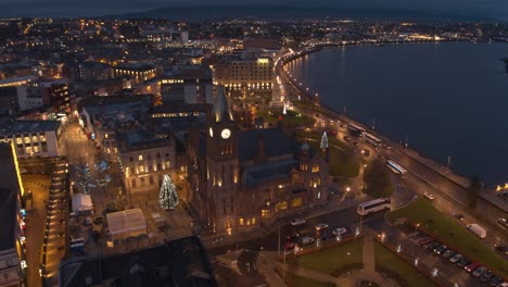 londonderry - derry - stroke city - legenderry night time aerial footage in uhd. cityscapes of the peace bridge, the foyle river, guildhall, st columb's cathedral, shipquay street, craigavon bridge