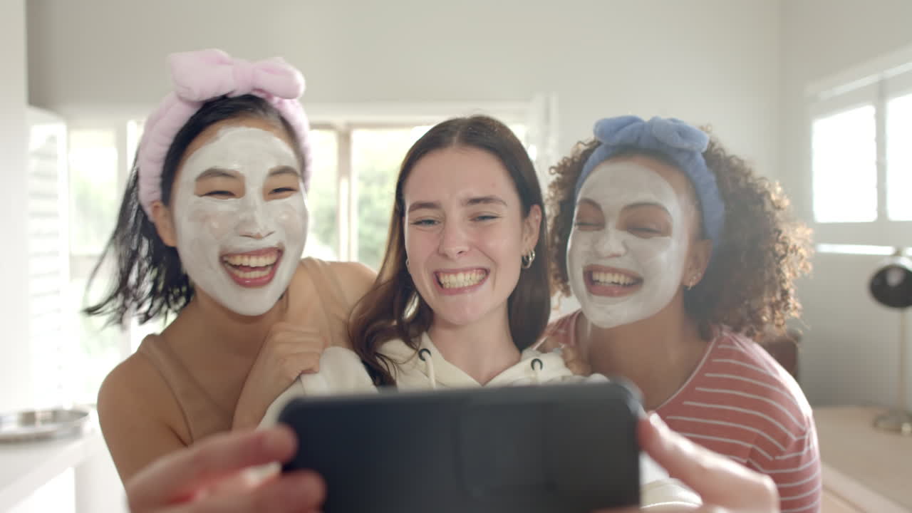 Taking selfie, three women friends with face masks smiling and enjoying together