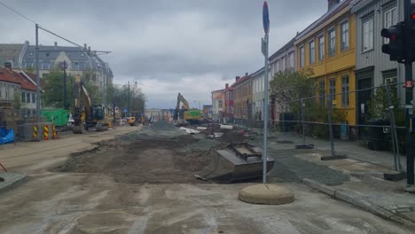 wide shot of a construction site in central trondheim, where an entire street is being rebuilt on a cloudy spring day in norway