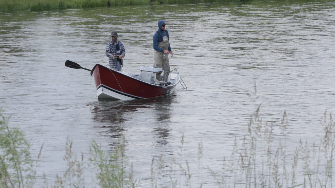 Fly fishing along the Snake River Chester Idaho from a small bass boat.