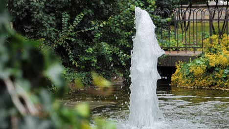 Eine-Nahaufnahme-Auf-Einem-Schönen-Gartenwasserbrunnen,-Der-In-Einem-Friedlichen-Teich-Plätschert