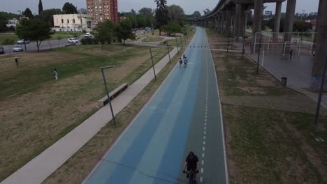 People-enjoy-the-sunset-at-the-park-they-are-walking-or-biking-on-the-street