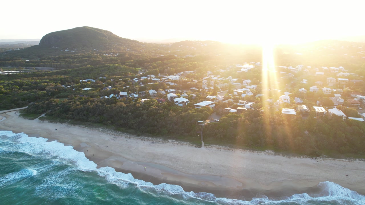 Sun Shining Over Port Arkwright Coastal Suburb At Sunrise In QLD, Australia. - aerial shot