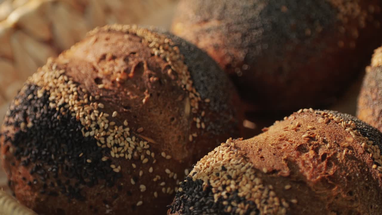 Fresh artesian bread on bakery shop close-up. Bread with black poppy garnish on top and white flour on top. Artisan bread is making by skill bakers using natural and high-quality ingredients. Food with health and flavour benefits.