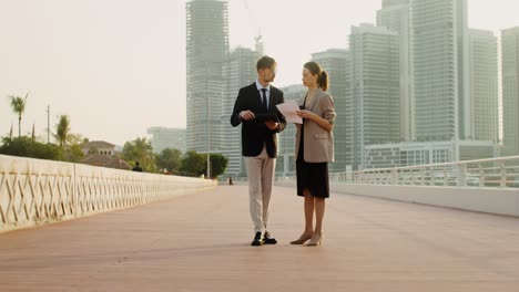 businesspeople discussing documents outdoors