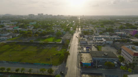 Slide-and-pan-aerial-shot-of-residential-borough.-Houses-and-trees-in-against-late-afternoon-sun.-Miami,-USA