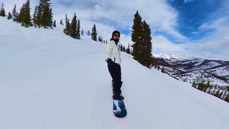 chill snowboarder down mountain in colorado