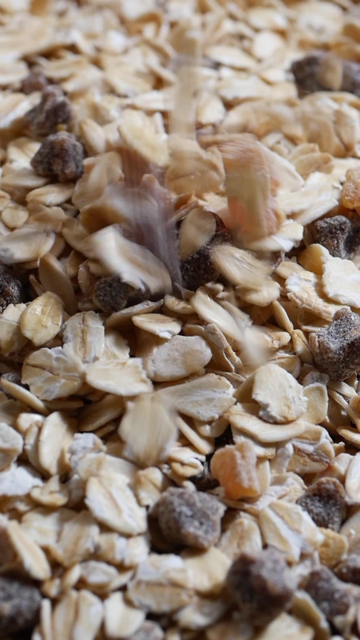 Oatmeal Flakes and Dried Fruits Falling in Slow Motion