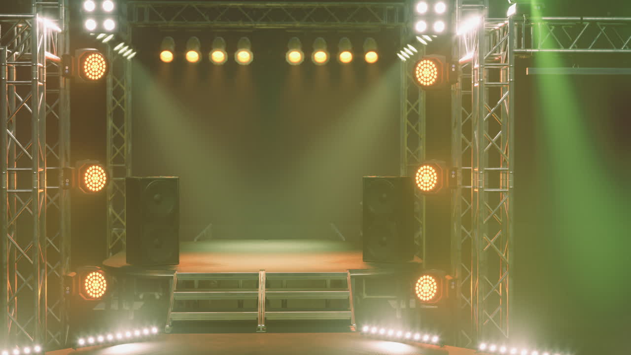 Concert stage set with colorful lights and sound equipment ready