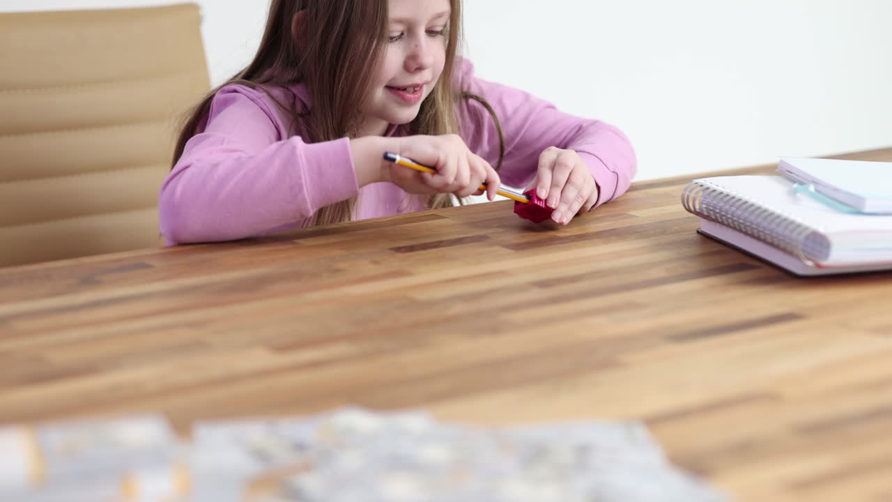 Girl sharpening a pencil