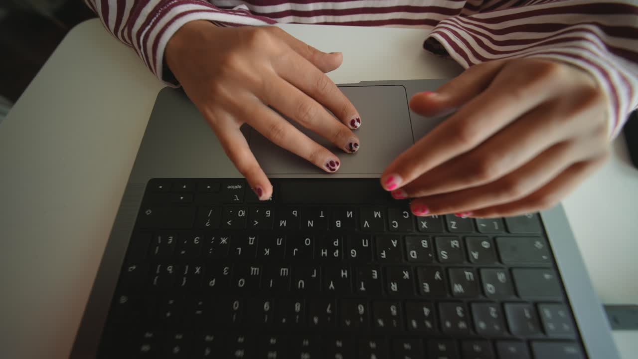 Close Up of Hands Typing and Using Trackpad on Laptop
