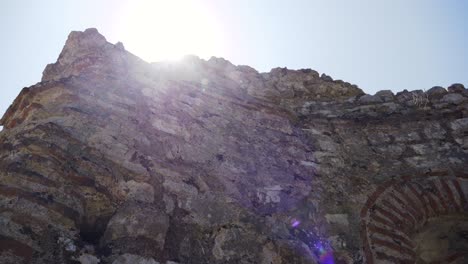 Butrint,-Albania,-rays-of-summer-sun-emerging-behind-ancient-ruins