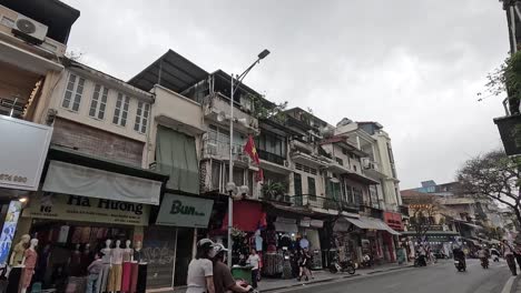 motorbikes and cars navigate bustling hanoi street