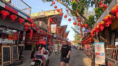a bustling seafood market in phuket, adorned with red lanterns, captures the lively atmosphere and cultural vibrancy