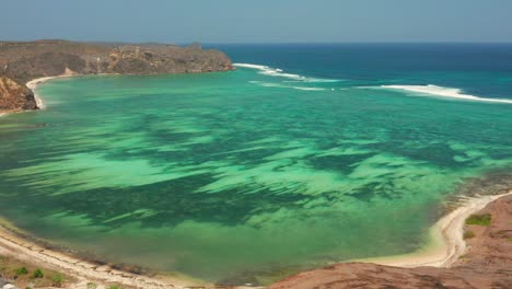 the white sand beach of tanjung aan in lombok, indonesia during a sunny day